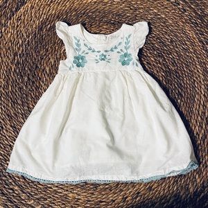 Flare dress with embroidered flowers.